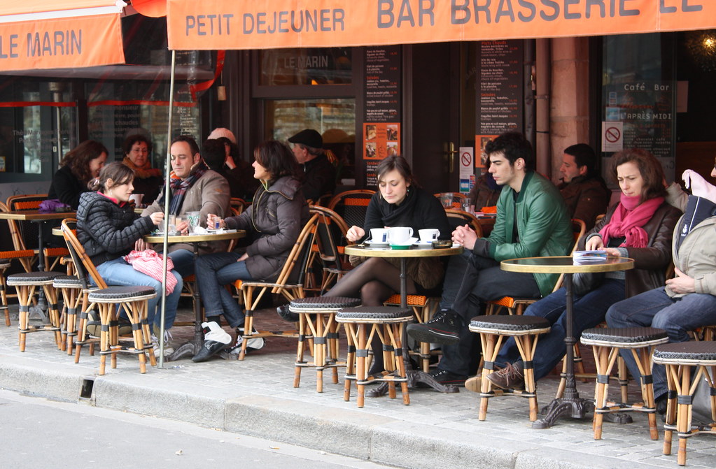 A couple talking at an outdoor cafe table