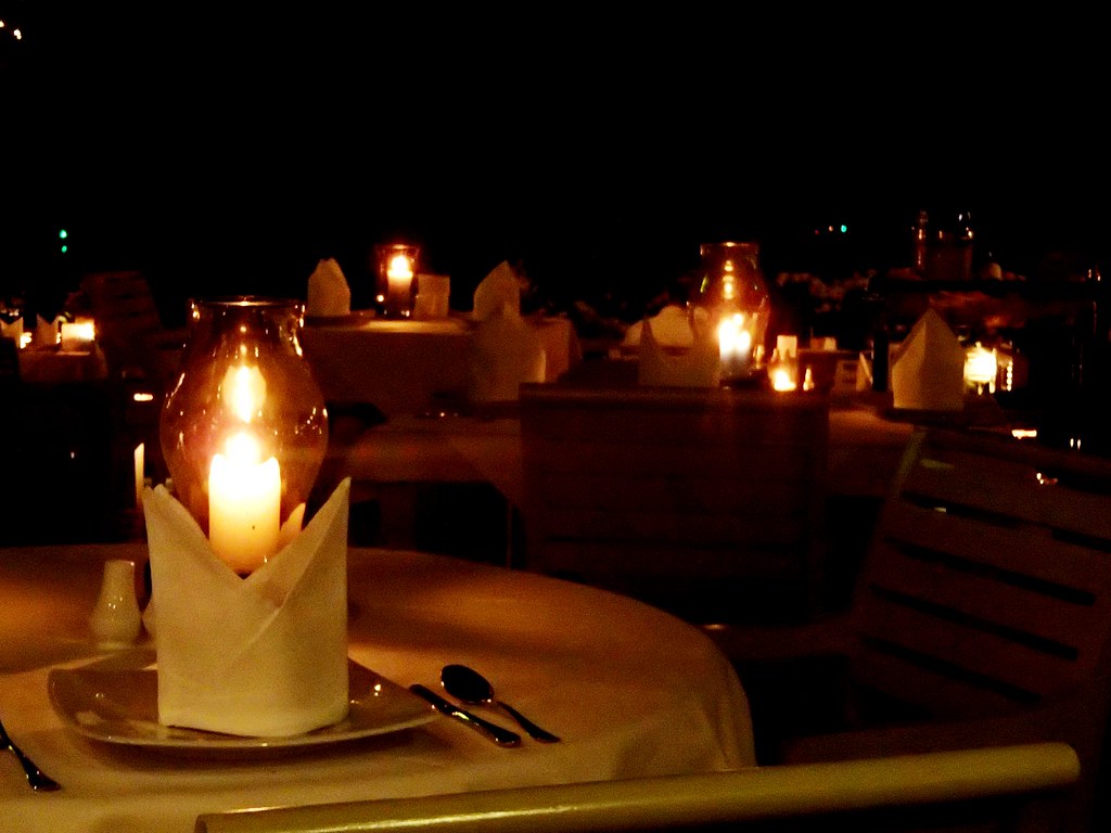 A couple sharing a candlelit dinner